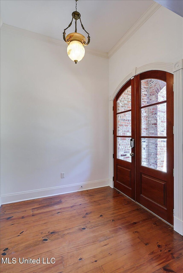 entryway with french doors, ornamental molding, and dark hardwood / wood-style floors