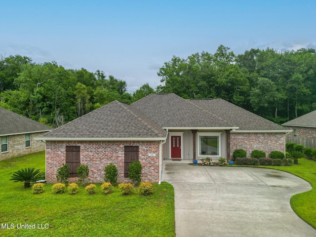 508 Dynsmore Pl, Long Beach, MS 39560 - view of front of house with roof with shingles, a front lawn, and brick siding