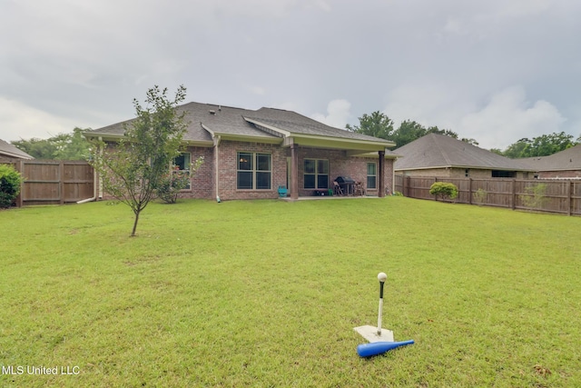 508 Dynsmore Pl, Long Beach, MS 39560 - rear view of house with a fenced backyard, brick siding, and roof with shingles