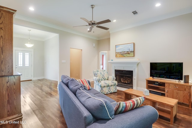 508 Dynsmore Pl, Long Beach, MS 39560 - living room featuring wood finished floors, a ceiling fan, recessed lighting, a fireplace with flush hearth, and ornamental molding