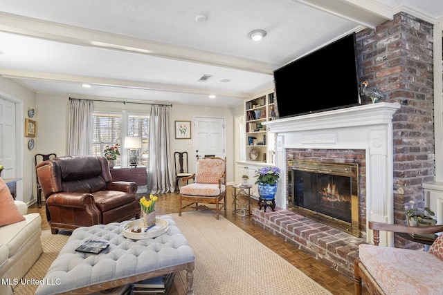 living room featuring a brick fireplace, visible vents, baseboards, and beam ceiling