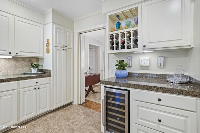 bar featuring tasteful backsplash, a bar, wine cooler, and crown molding