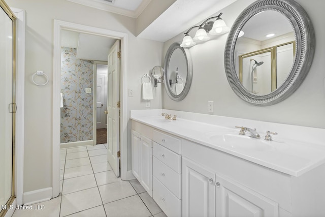 full bathroom with double vanity, wallpapered walls, a stall shower, tile patterned flooring, and a sink