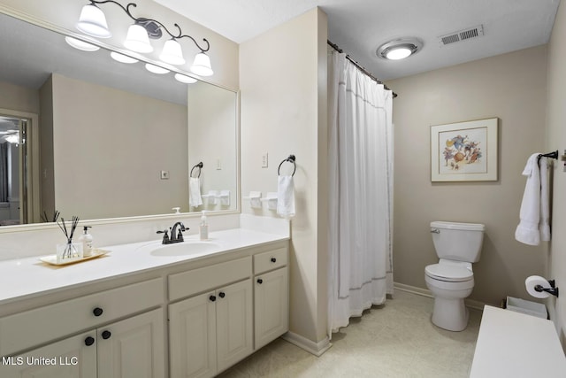 bathroom featuring baseboards, visible vents, toilet, tile patterned floors, and vanity