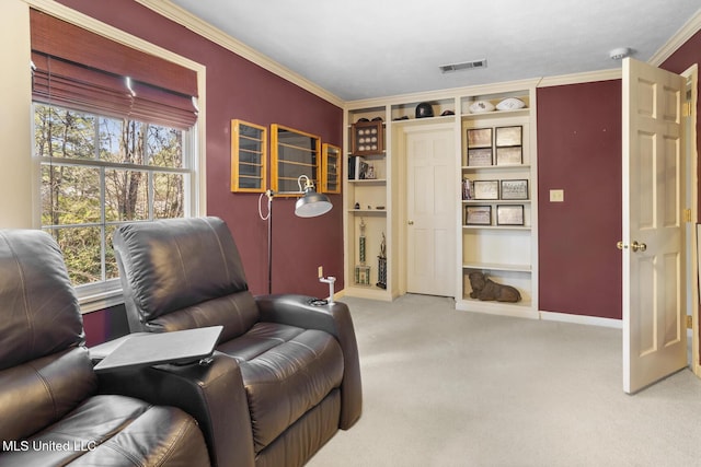 sitting room with carpet, visible vents, baseboards, and ornamental molding