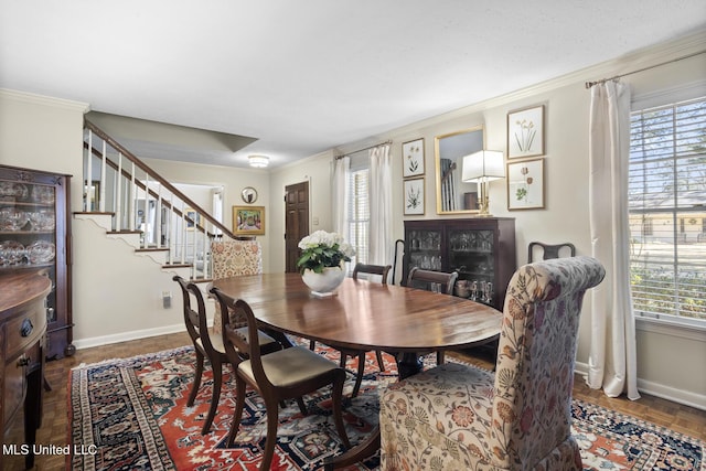 dining space featuring ornamental molding, a wealth of natural light, and baseboards