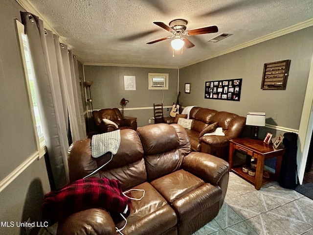 309 College St, Carthage, MS 39051 - tiled home theater room featuring ornamental molding, a textured ceiling, a ceiling fan, and visible vents