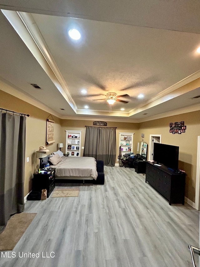 309 College St, Carthage, MS 39051 - bedroom featuring crown molding, a raised ceiling, and light wood-style floors