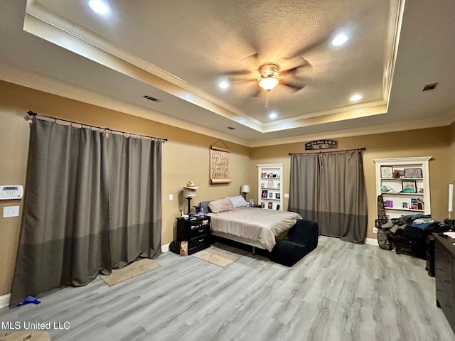 309 College St, Carthage, MS 39051 - bedroom with a tray ceiling, recessed lighting, baseboards, crown molding, and light wood-type flooring
