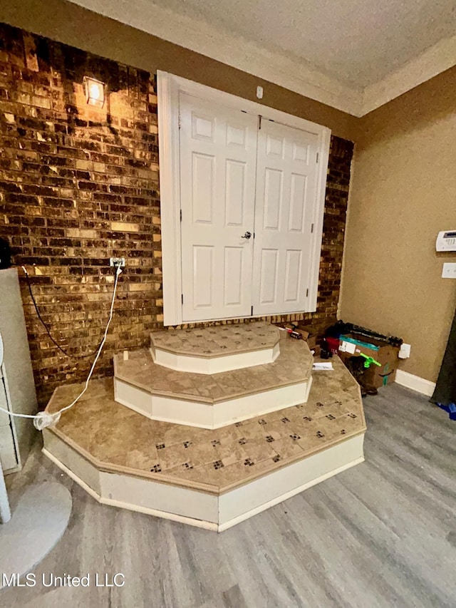 309 College St, Carthage, MS 39051 - foyer entrance featuring a textured ceiling, baseboards, and wood finished floors