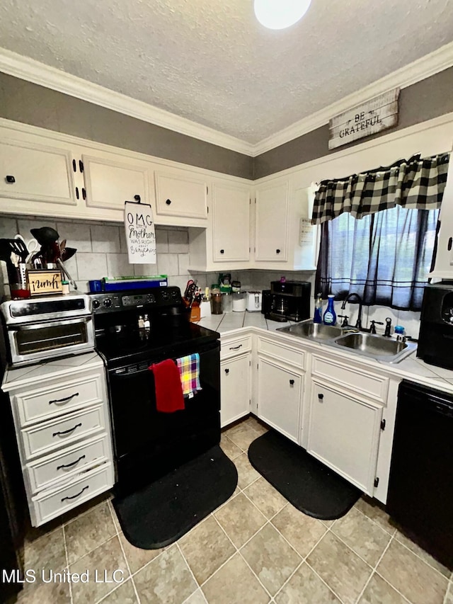 309 College St, Carthage, MS 39051 - kitchen featuring a sink, ornamental molding, black appliances, light countertops, and white cabinets