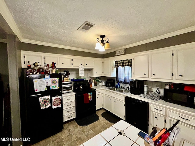 309 College St, Carthage, MS 39051 - kitchen featuring a sink, white cabinetry, visible vents, black appliances, and ornamental molding