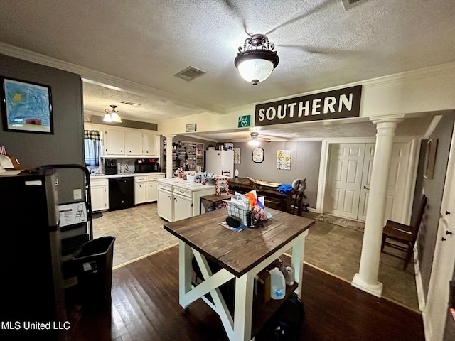 309 College St, Carthage, MS 39051 - dining space with a textured ceiling, ornamental molding, visible vents, wood finished floors, and ornate columns