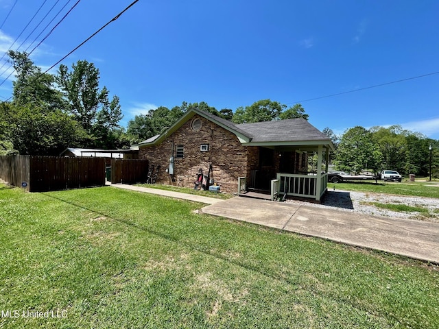 309 College St, Carthage, MS 39051 - exterior space featuring a porch, fence, a yard, and brick siding