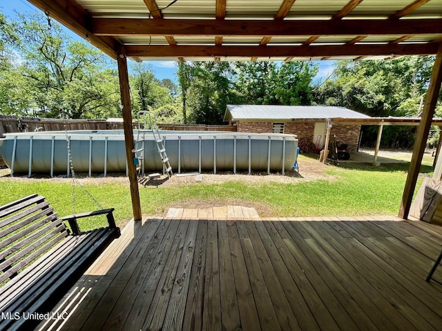 309 College St, Carthage, MS 39051 - deck with fence, an outdoor pool, and a lawn
