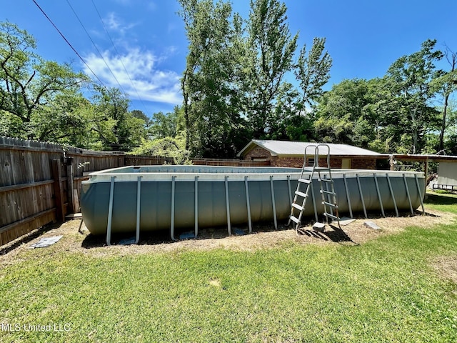 309 College St, Carthage, MS 39051 - view of pool with a yard, a fenced in pool, and a fenced backyard