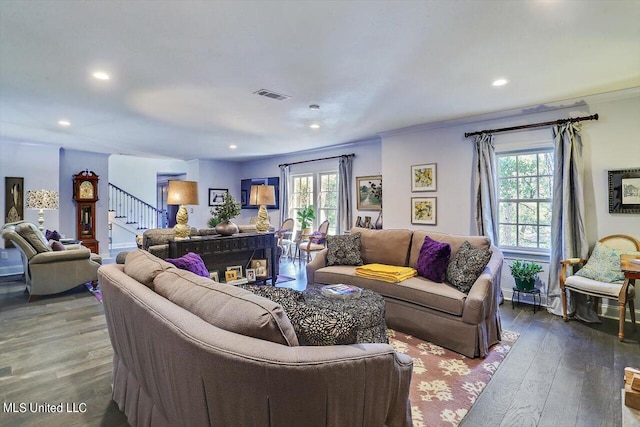 living room with ornamental molding, a wealth of natural light, and hardwood / wood-style floors