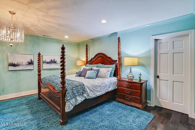 bedroom with ornamental molding and dark wood-type flooring