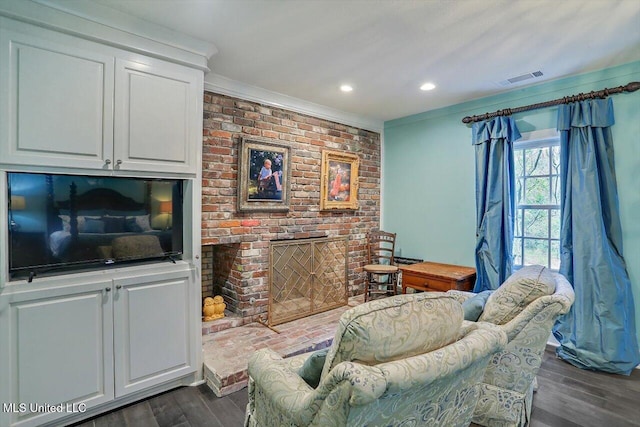 living room featuring crown molding, a brick fireplace, and dark hardwood / wood-style flooring