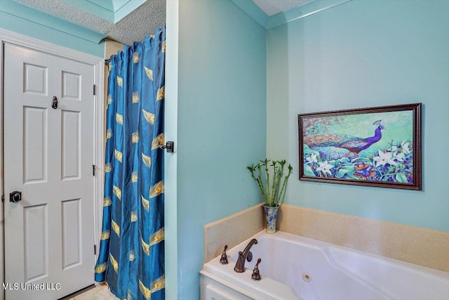 bathroom featuring a textured ceiling and a tub to relax in