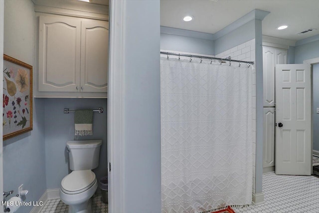 bathroom featuring toilet, tile patterned floors, and curtained shower