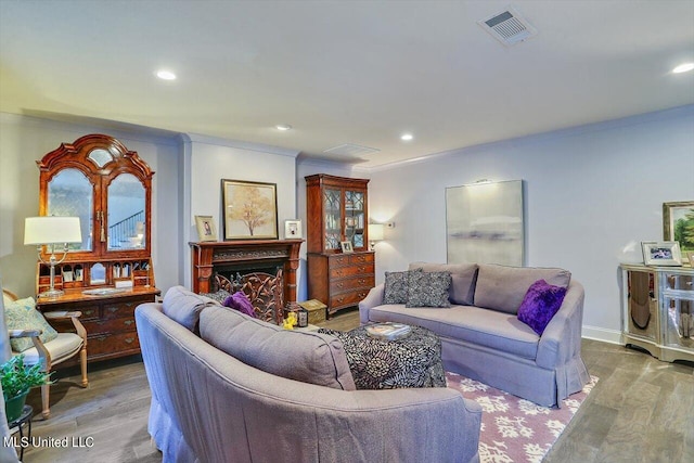 living room with light hardwood / wood-style flooring and ornamental molding