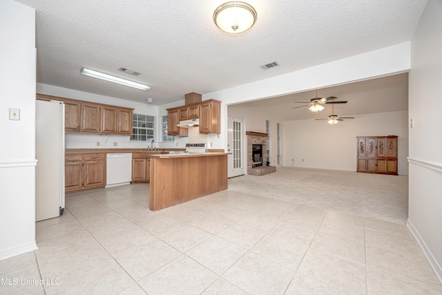 108 Water Oaks Cv, Ocean Springs, MS 39564 - kitchen with white appliances, under cabinet range hood, open floor plan, light countertops, and ceiling fan