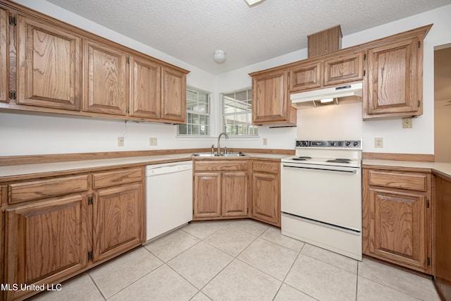 108 Water Oaks Cv, Ocean Springs, MS 39564 - kitchen featuring white appliances, a sink, under cabinet range hood, light tile patterned floors, and a textured ceiling