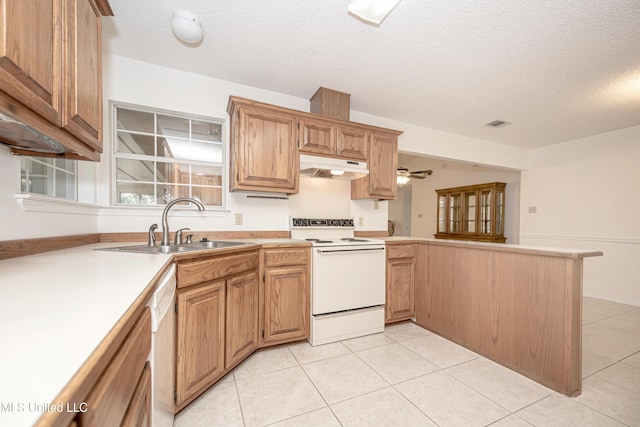 108 Water Oaks Cv, Ocean Springs, MS 39564 - kitchen with white appliances, under cabinet range hood, a peninsula, a textured ceiling, and a sink