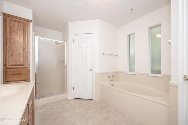 108 Water Oaks Cv, Ocean Springs, MS 39564 - bathroom featuring a stall shower, a bath, vanity, and a textured ceiling