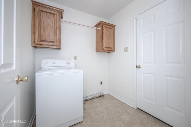 108 Water Oaks Cv, Ocean Springs, MS 39564 - laundry area featuring washer / dryer, cabinet space, baseboards, and a textured ceiling