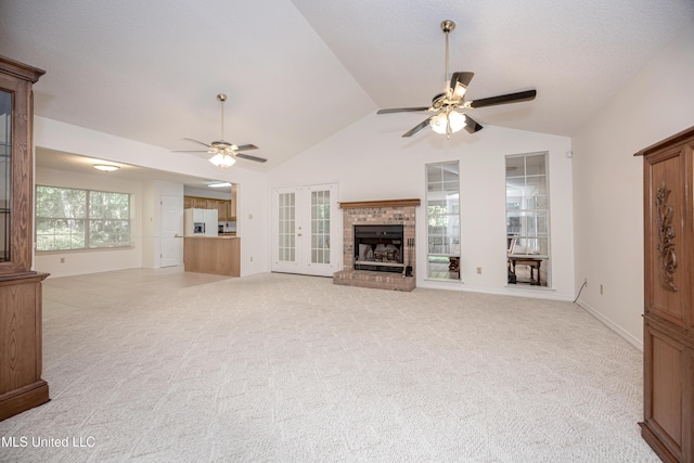 108 Water Oaks Cv, Ocean Springs, MS 39564 - unfurnished living room with ceiling fan, lofted ceiling, a brick fireplace, and light colored carpet