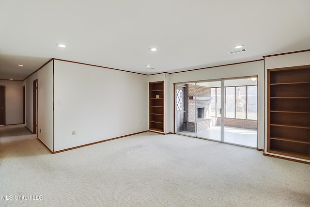 unfurnished living room featuring built in shelves, a fireplace, and crown molding