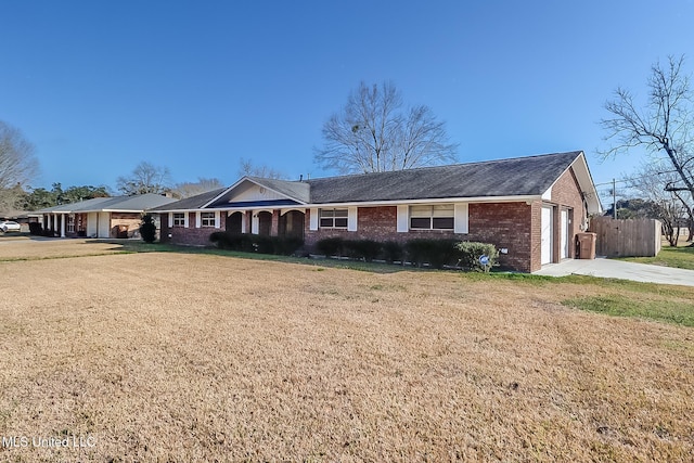 single story home featuring a garage and a front lawn