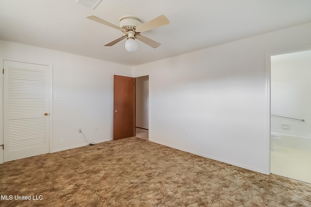 carpeted spare room featuring ceiling fan