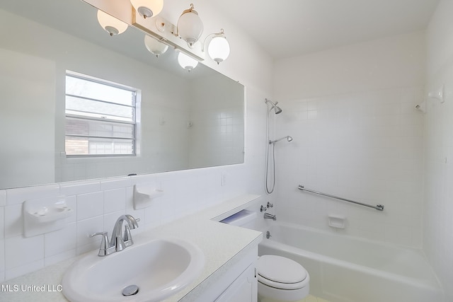 full bathroom with vanity, tiled shower / bath, decorative backsplash, and toilet