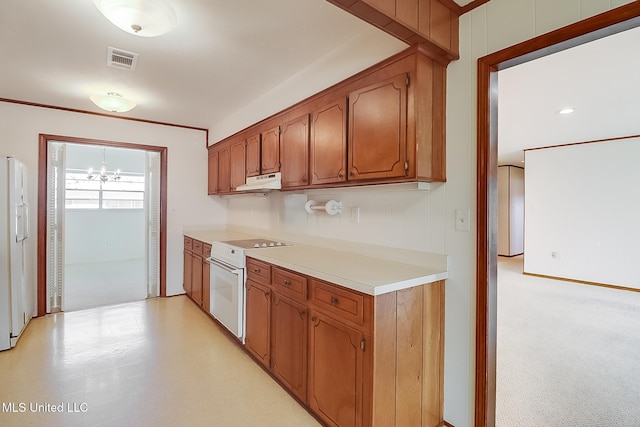 kitchen featuring white appliances and a notable chandelier