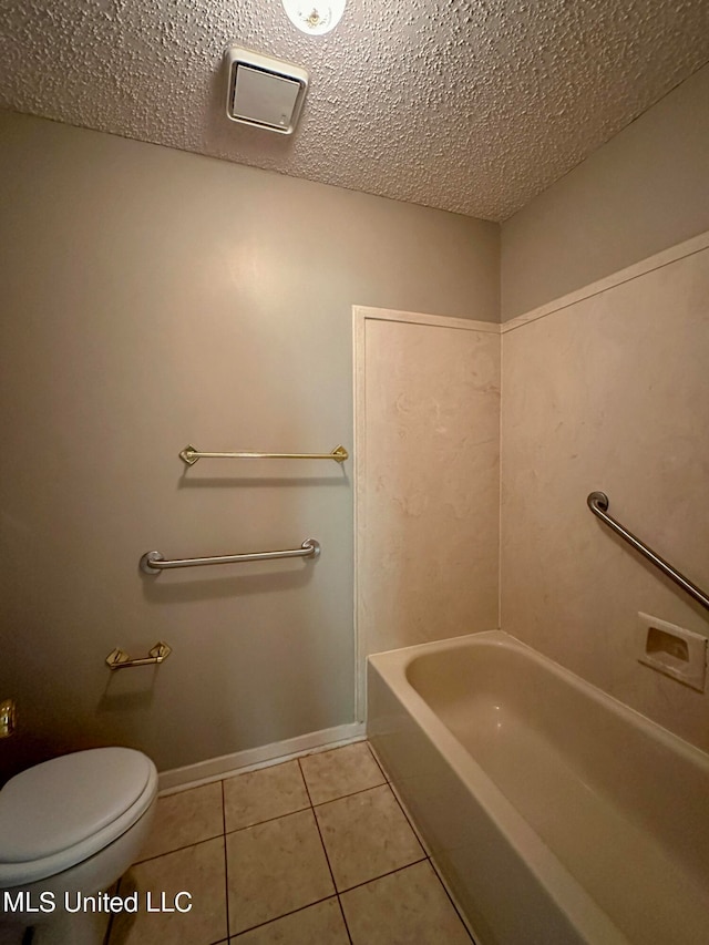 bathroom with tile patterned floors, a textured ceiling, and toilet