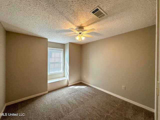 empty room with a textured ceiling, ceiling fan, and carpet floors