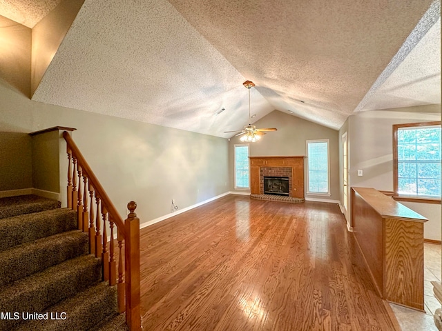 living room featuring light hardwood / wood-style flooring, a textured ceiling, and a wealth of natural light