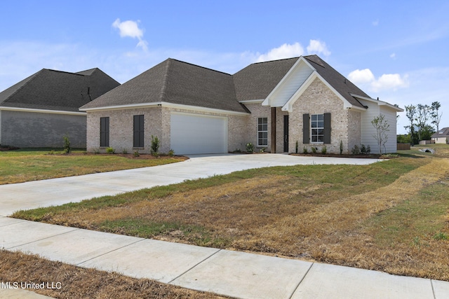 view of front of property with a front yard and a garage