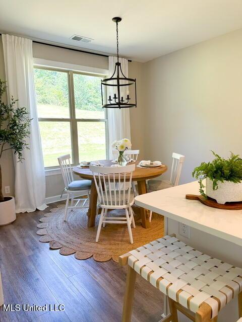 dining room featuring hardwood / wood-style flooring and a chandelier