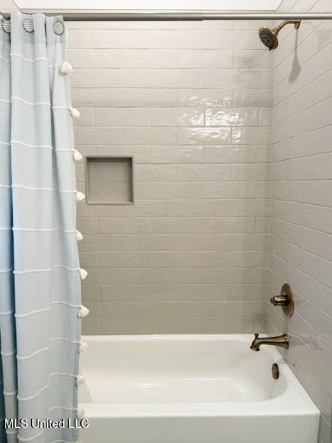 bathroom with shower / bath combination with curtain