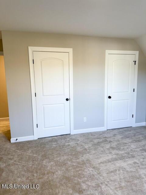 unfurnished bedroom with light colored carpet