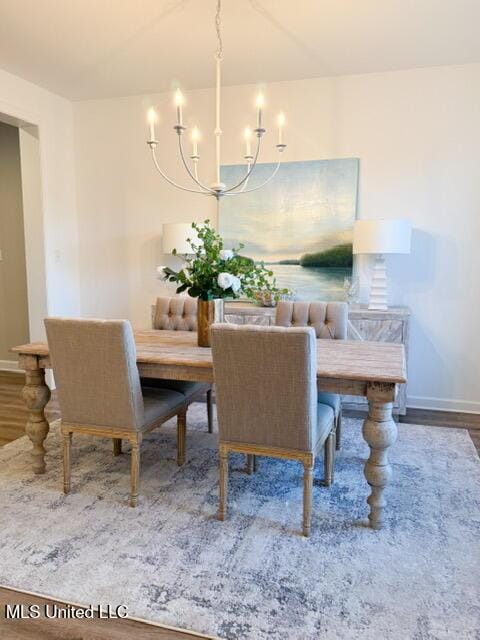 dining space featuring a chandelier and wood-type flooring