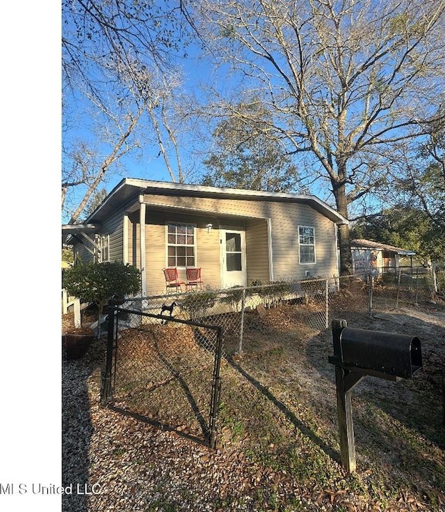 view of front facade with a fenced front yard and a gate