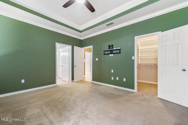 1585 Knoll Ct, Biloxi, MS 39532 - unfurnished bedroom featuring carpet, a spacious closet, baseboards, ornamental molding, and ceiling fan