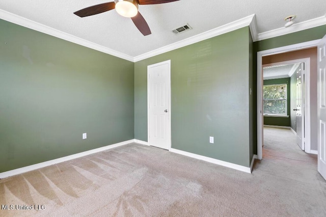 1585 Knoll Ct, Biloxi, MS 39532 - unfurnished bedroom featuring carpet floors, crown molding, baseboards, ceiling fan, and a textured ceiling