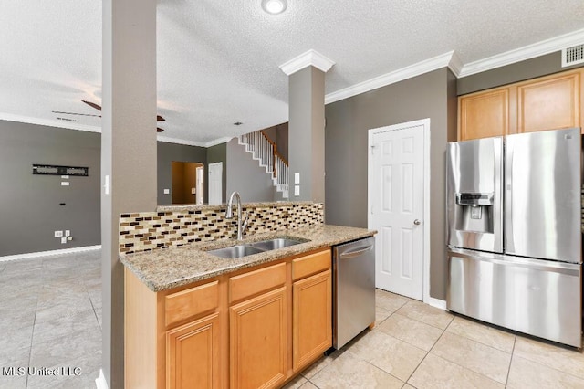 1585 Knoll Ct, Biloxi, MS 39532 - kitchen with stainless steel appliances, a sink, backsplash, light stone countertops, and ornamental molding