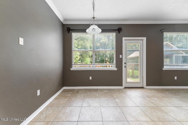 1585 Knoll Ct, Biloxi, MS 39532 - unfurnished dining area featuring ornamental molding, baseboards, a textured ceiling, and tile patterned flooring